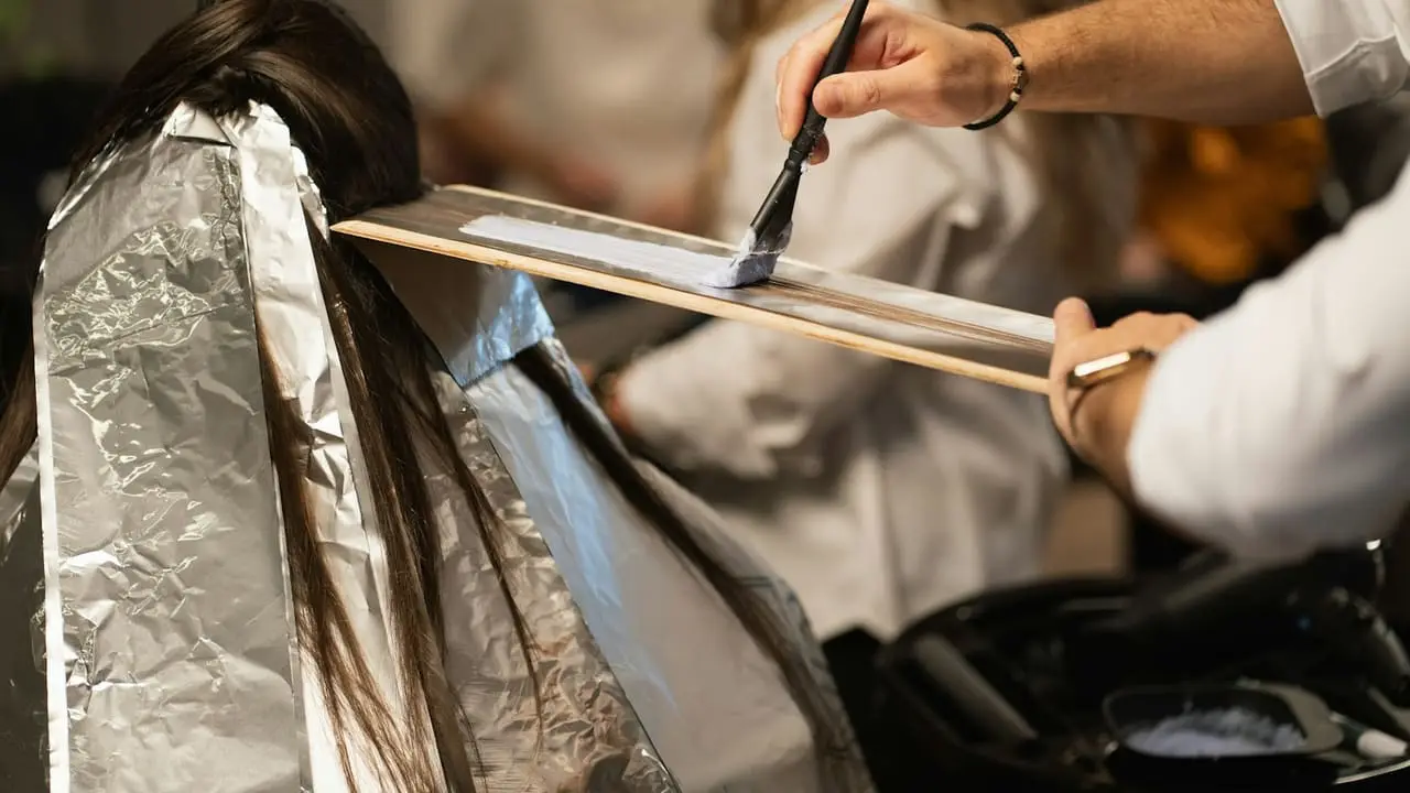 Clip of a colourist applying hair colour