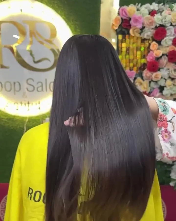 Long, sleek, straight dark hair after a smoothing treatment