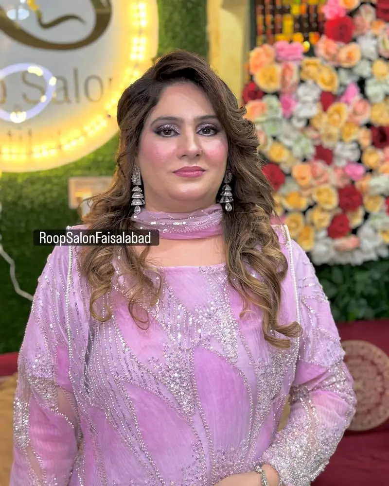 Client in a lilac outfit with smoky eye makeup and soft curls