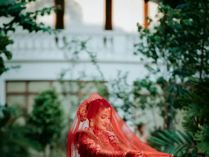 Bride in a red bridal outfit and veil