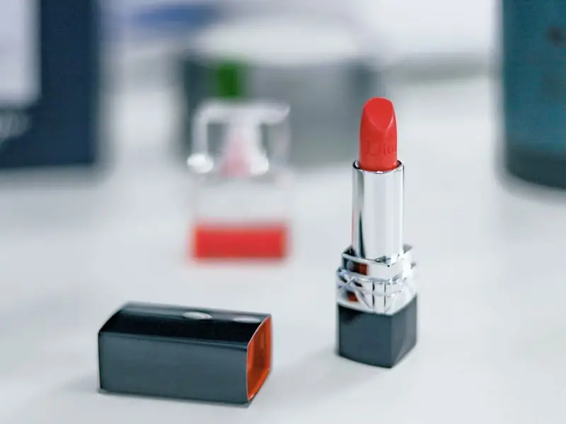 Lipstick and makeup products on a white surface