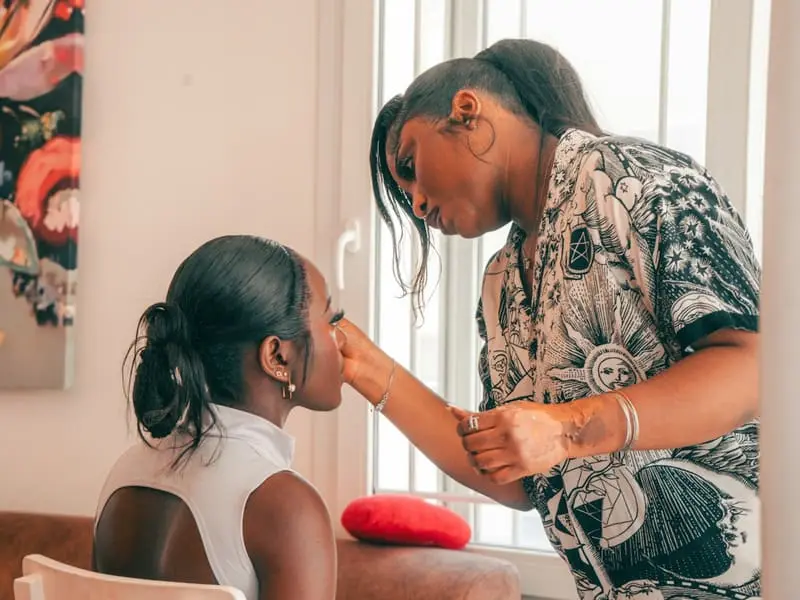 Makeup artist applying makeup to a client